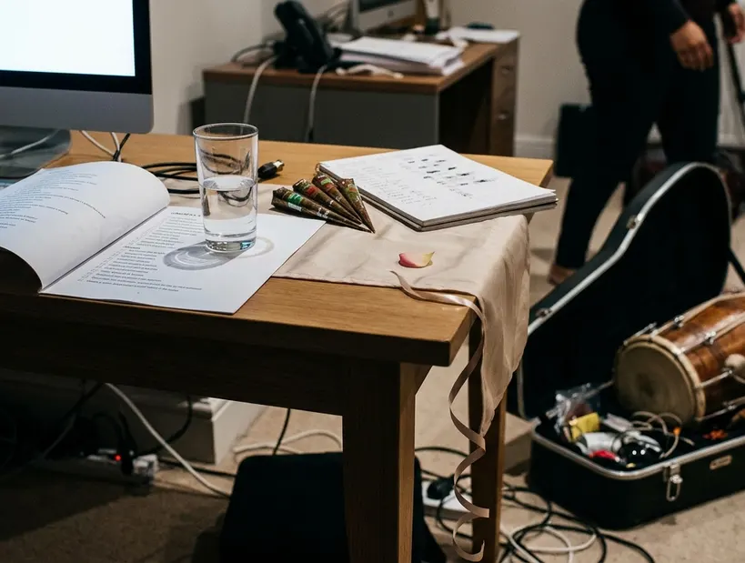 Documentation or planning materials on desk, a printed Nikah checklist curling at one corner under